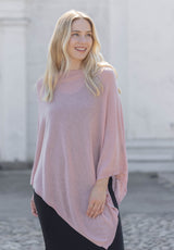 Outdoor image of model wearing the Juolas Poncho in color rosa